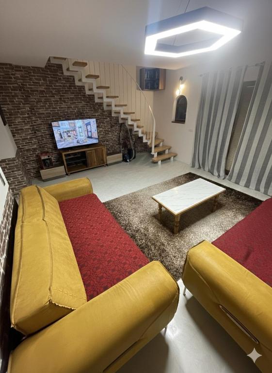 a living room with a couch and a tv at House in Center in Skopje