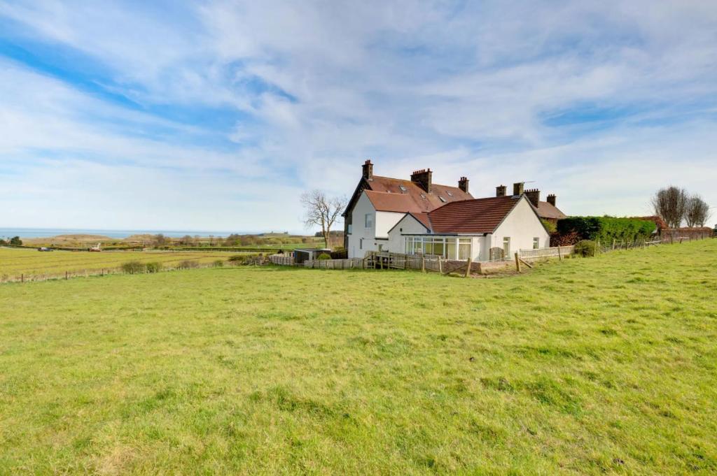 a house on a hill in a field at Brackenrigg Embleton in Embleton