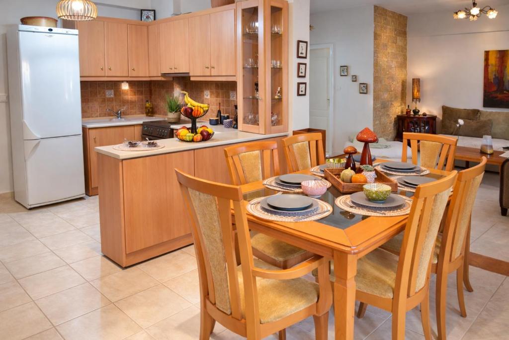 a kitchen with a table and chairs and a kitchen with a refrigerator at Mola's Memories in Mola Kalyva