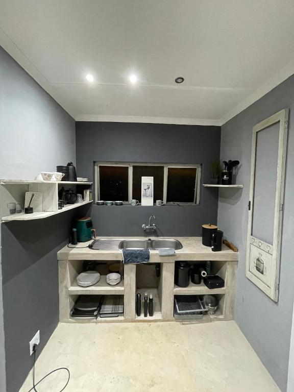a bathroom with a sink and a counter at Mtunzini Rustic Retreat in Mtunzini