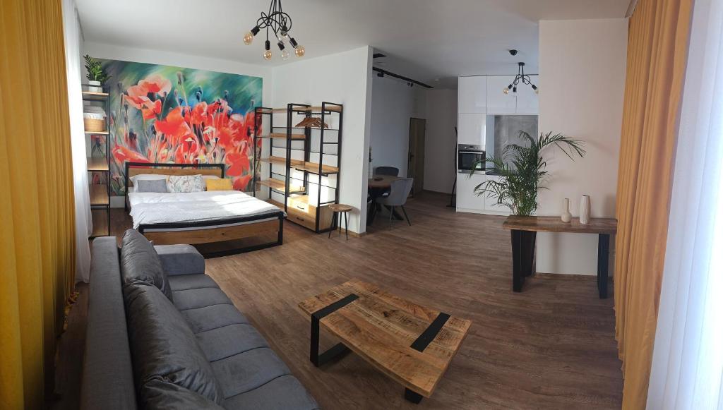 a living room with a bed and a couch at Sauna Cafee & Beds in Český Těšín