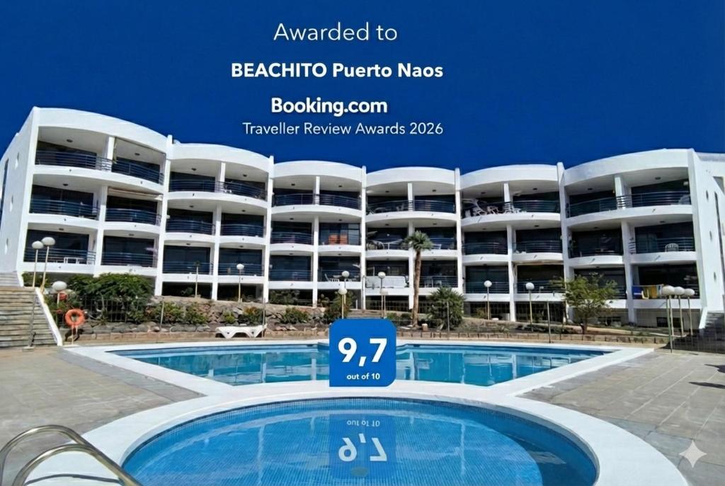 a large apartment building with a pool in front of it at BEACHITO Puerto Naos in Puerto Naos