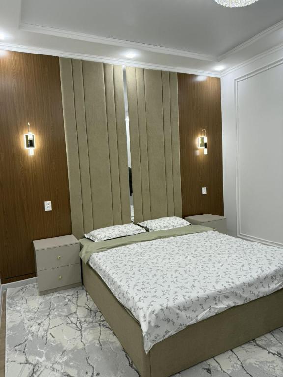 a bedroom with a large bed in a room at Asolat house in Urganch
