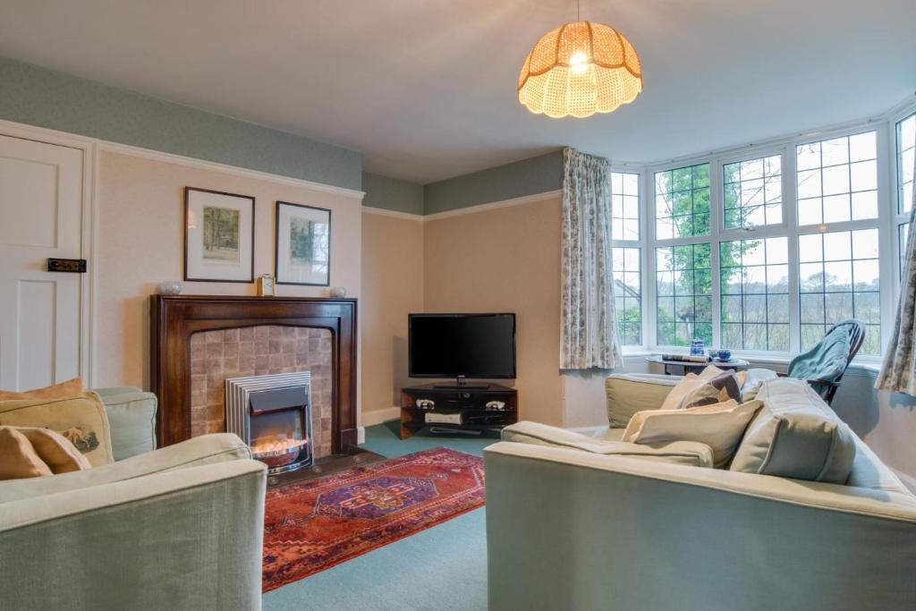 a living room with two couches and a fireplace at 2 Bed in Warkworth oc-nb319 in Warkworth