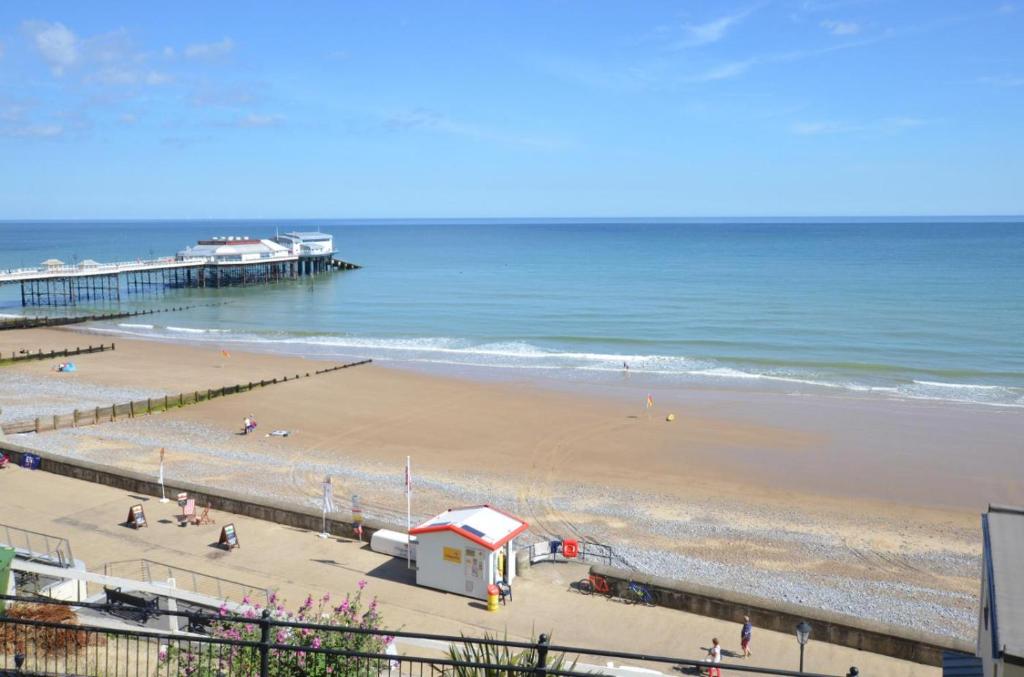 a view of a beach with a pier and the ocean at 2 Bed in Cromer oc-f28893 in Cromer