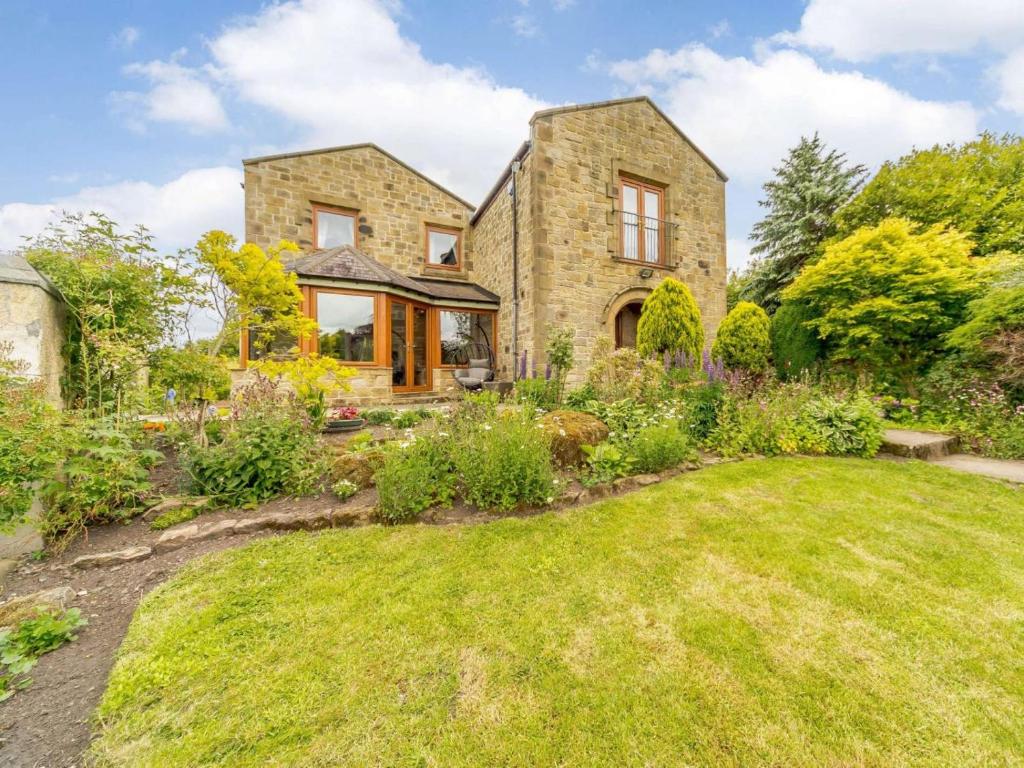 a stone house with a garden in the foreground at 5 Bed in Durham oc-85257 in Lanchester