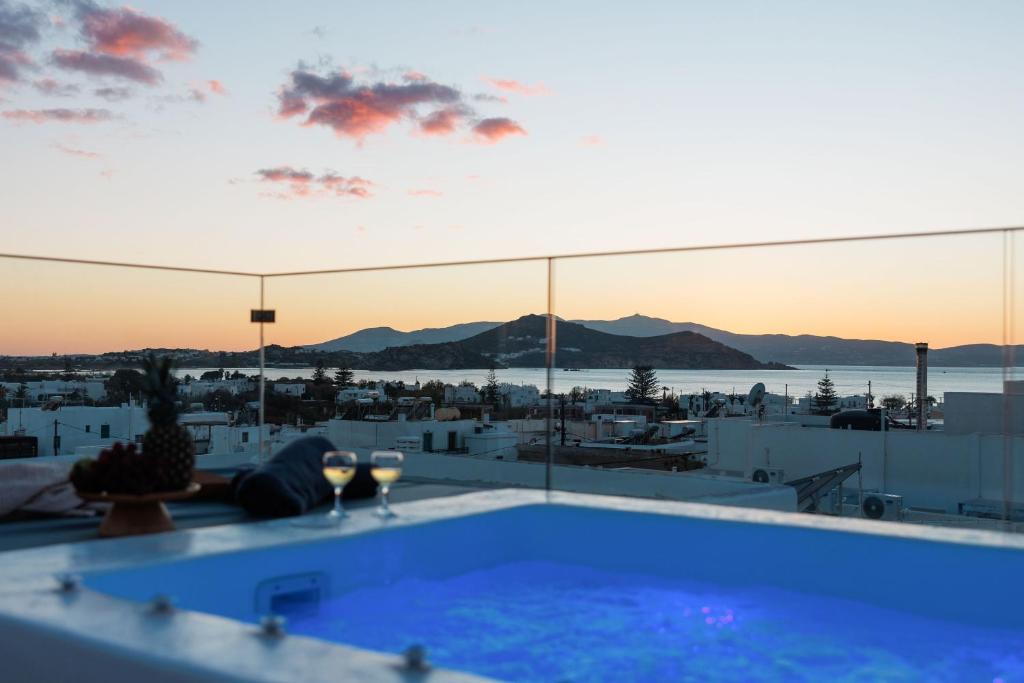 a pool on the roof of a building with a view at Kalypso Vacation Home Naxos Town in Naxos Chora