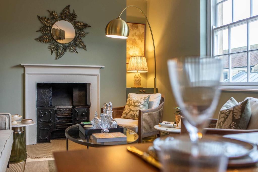 a living room with a table with a wine glass at Old Orchard Elegance - Private Parking in Bath