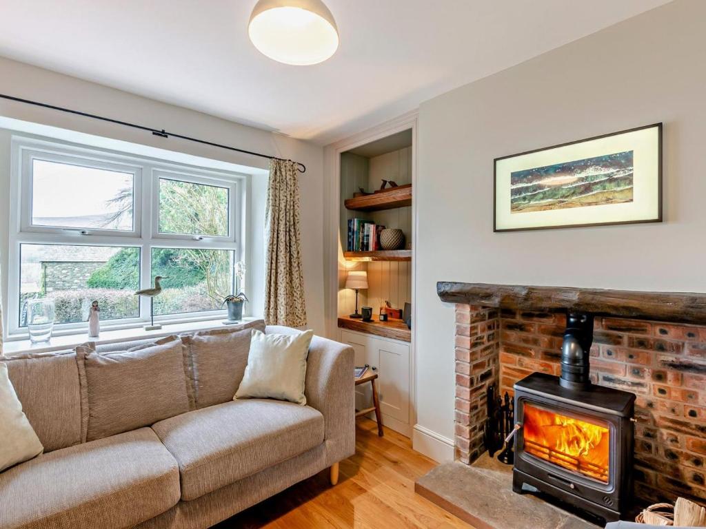 a living room with a couch and a fireplace at 2 Bed in Keswick oc-90064 in Threlkeld