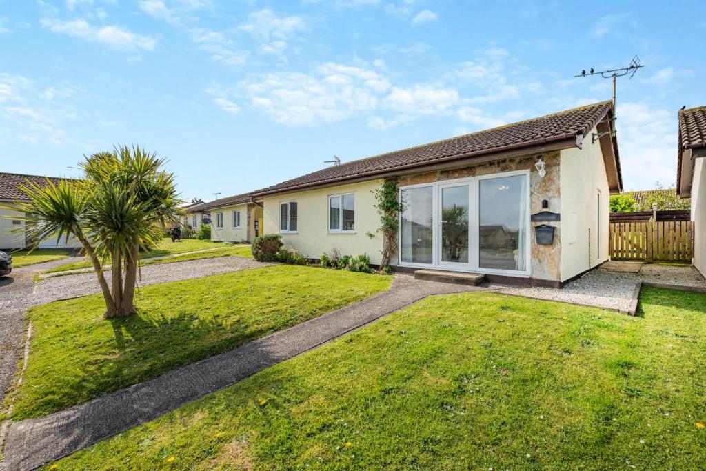 a house with a palm tree in the yard at 3 Bed in Padstow oc-p00131 in Saint Merryn