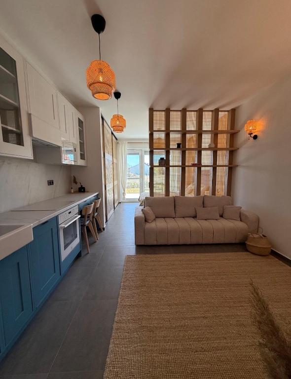 a living room with a couch in a kitchen at The Balaton Nest! in Alsóörs