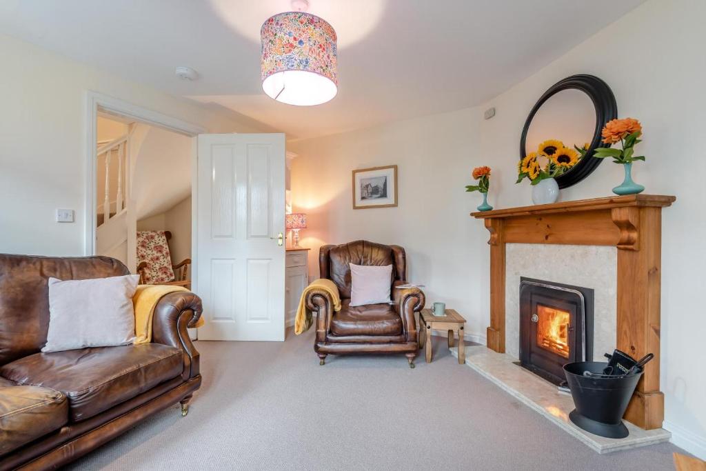 a living room with a couch and a fireplace at 2 Bed in Weobley oc-c32945 in Weobley
