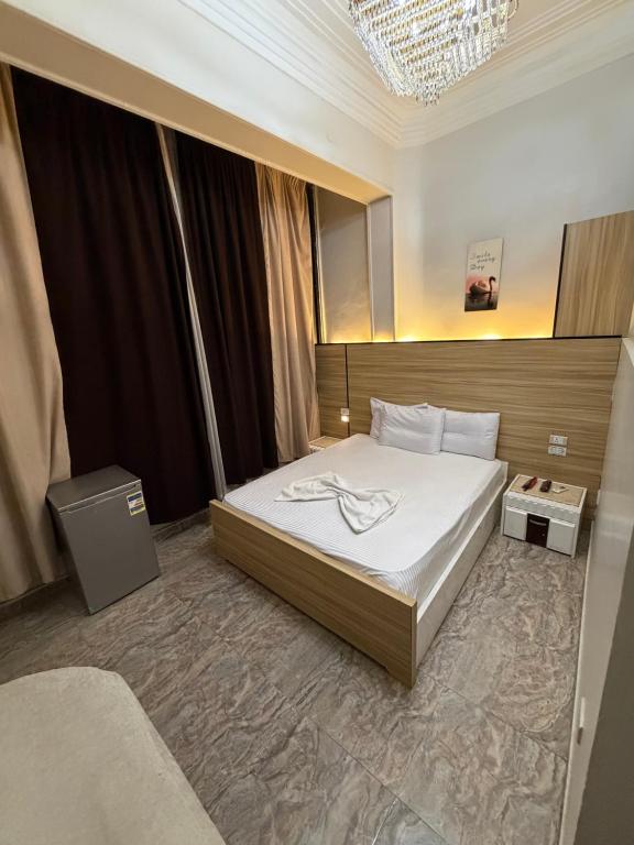 a hotel room with a bed and a mirror at Abdeen Cairo Hostel in Cairo