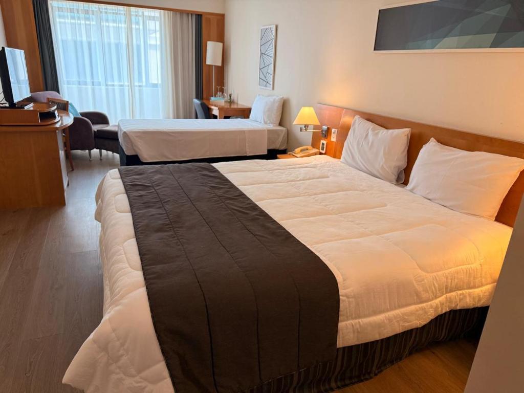 a hotel room with two beds in a room at Hotel & Residence Alphaville in Barueri