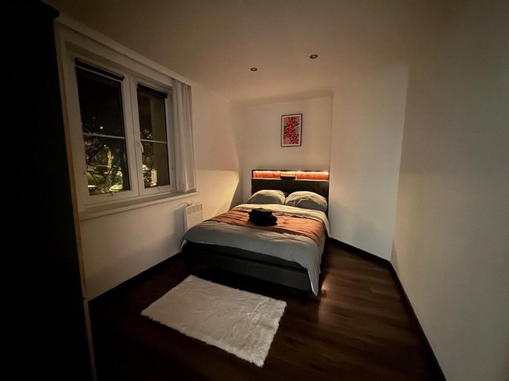 a small bedroom with a bed and a window at Ubytování Resslova in Ústí nad Labem