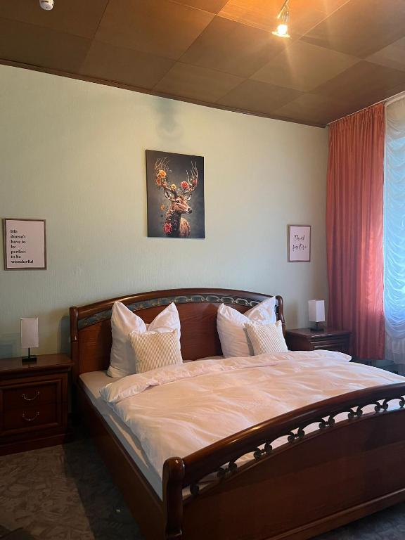 a bedroom with a large bed with white sheets and pillows at Ruheoase in Konz-Könen in Konz