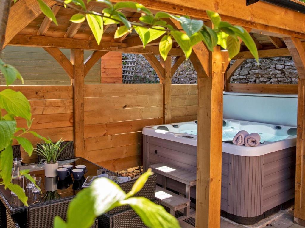 an outdoor hot tub in a wooden pergola at 3 Bed in Bakewell oc-90384 in Bakewell