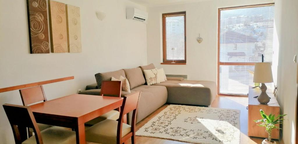 a living room with a couch and a table at Mountain View Apartment Bansko in Bansko