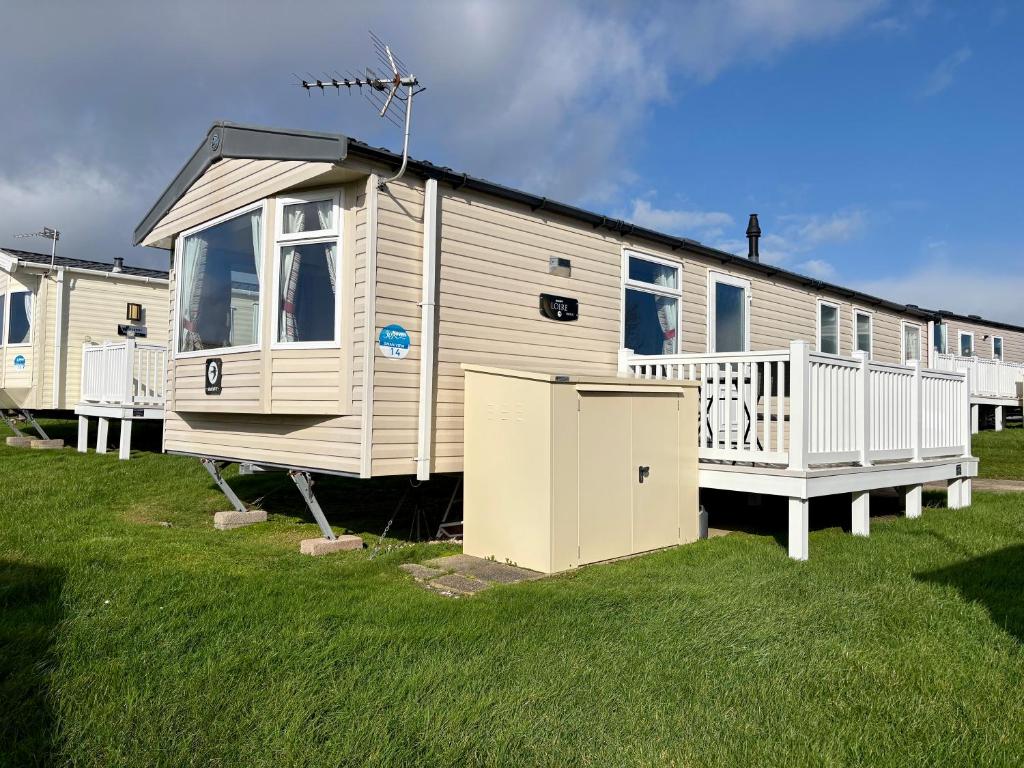 a mobile home is parked in the grass at Chesil View in Wyke Regis