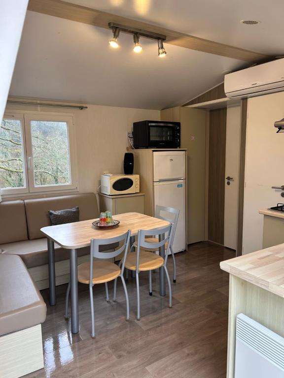 a small kitchen and dining room with a table and chairs at Mobil-home 1 in Quimper