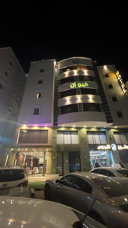 a building with cars parked in front of it at فيو المنسك in Abha