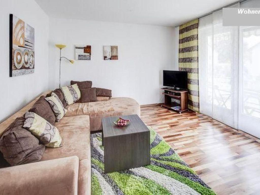 a living room with a couch and a tv at Apartment Fe-Wohnung Augsburg by Interhome in Augsburg