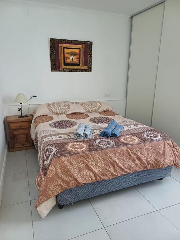a bedroom with a bed with two shoes on it at il Mandarino in Bahía Blanca