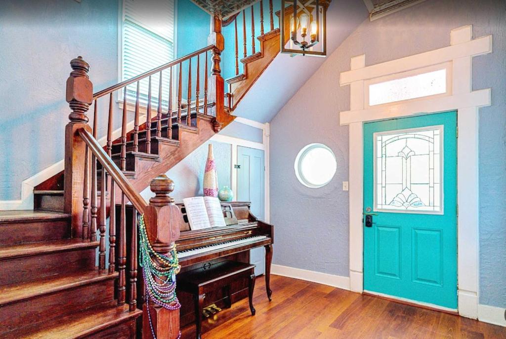 a staircase in a home with a blue door at Surf & Strand Unit B in Galveston