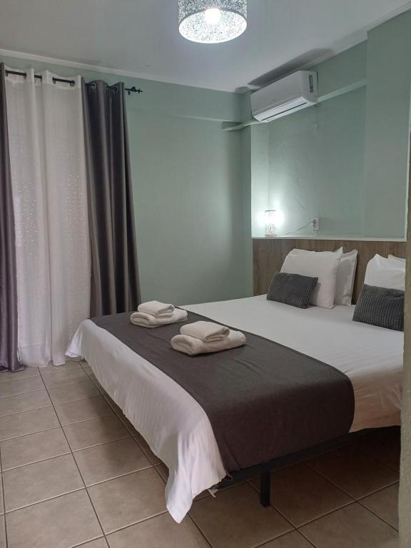 a bedroom with two beds with towels on them at VATA apartaments in Thessaloniki