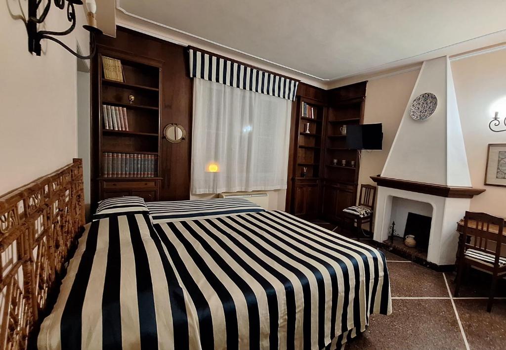 a bedroom with two beds and a fireplace and a window at Red Horse in Pisa