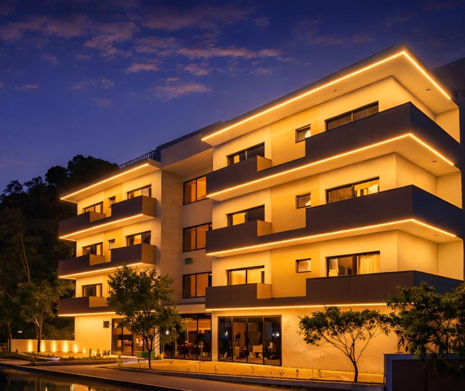 a large white building with lights on at Hotel Quinta do Lago in Cunha