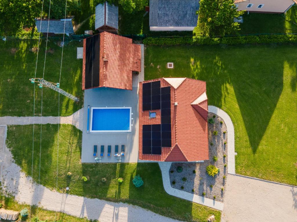 an overhead view of a house with solar panels on the yard at Villa Brusiana with heated pool in Brušane