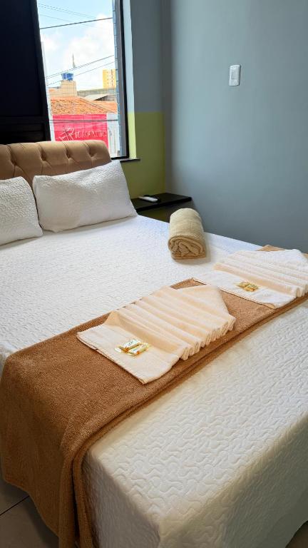 a bed with towels sitting on top of it at Hotel Brasilia in Aracaju