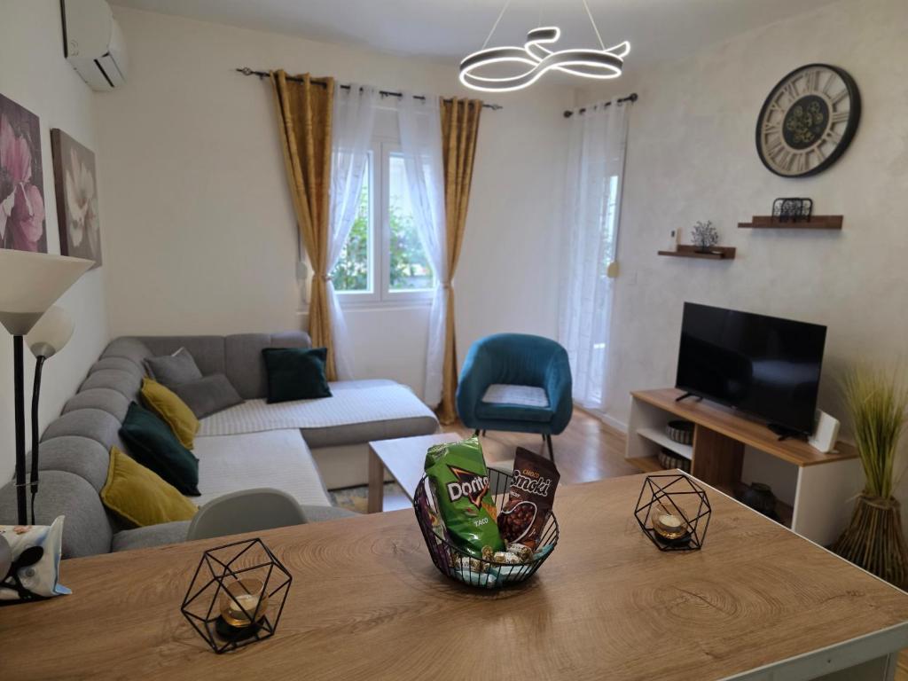 a living room with a couch and a table at Apartman Stars in Podgorica