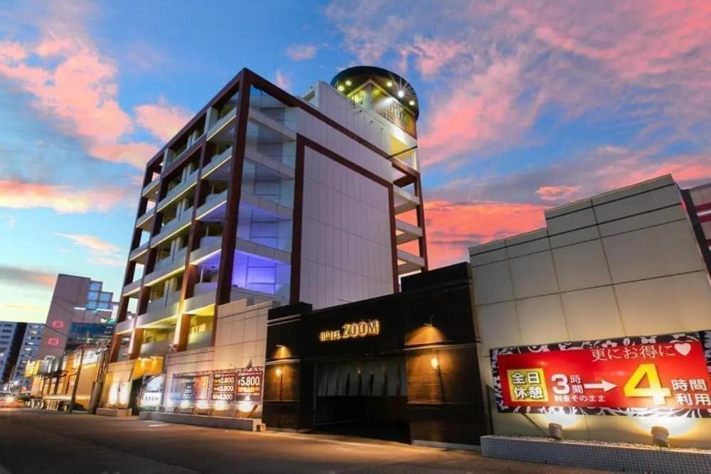 a building with a sign on the side of it at HOTEL ZOOM - Couple's Hotel in Beppu