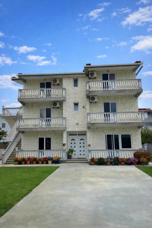 a large white building with white balconies on it at Belmare in Ulcinj