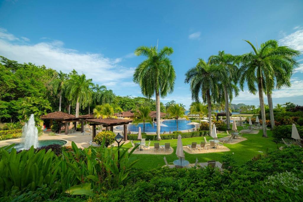 a resort with a fountain and a pool at Bella Vista 3F 3 bdr beach club view in Los Suenos in Herradura