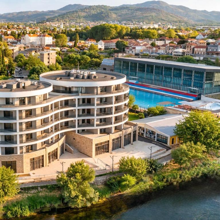 an aerial view of a building with a swimming pool at Apartman TERRASSE in Trebinje