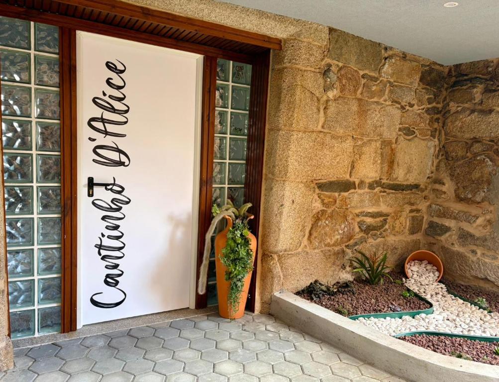 a door to a building with a sign on it at Cantinho D` Alice in Armamar