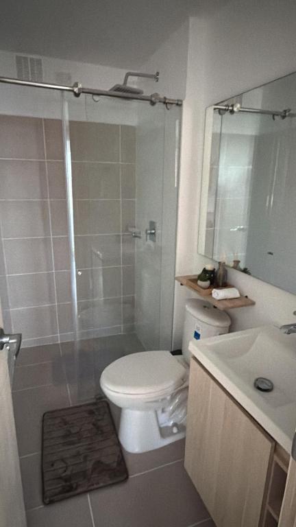 a bathroom with a toilet and a shower and a sink at Cartagena Serena Del Mar INAWA in Cartagena de Indias