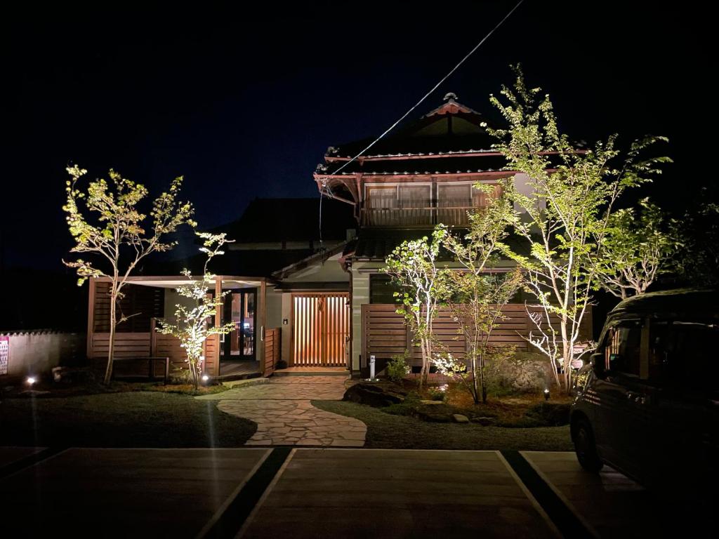 a house with christmas lights in front of it at night at Kikuchi Mirai Base - 菊池みらいベース in Kikuchi