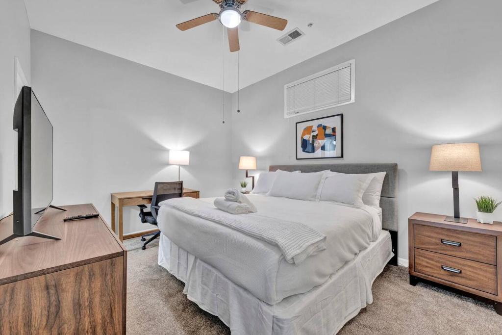 a bedroom with a bed and a flat screen tv at Central Downtown Condo | Parking & Pool Table in Cleveland