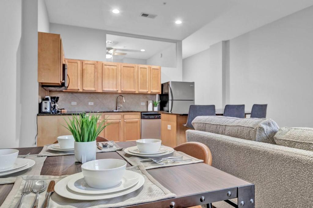 a kitchen and living room with a table and a couch at Theater District Gem • Downtown Hideaway in Cleveland