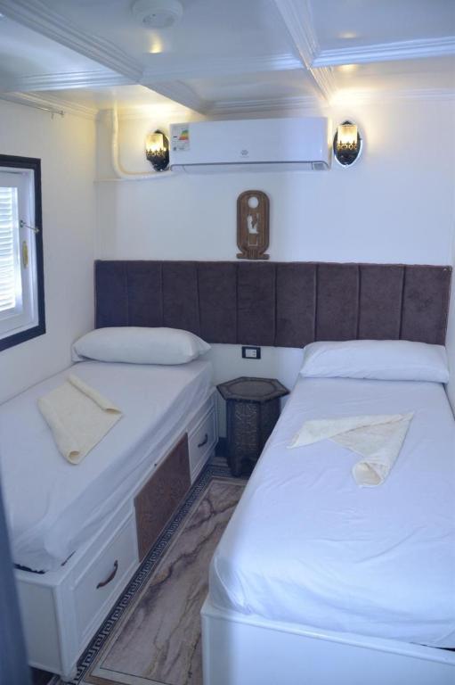 two beds in a small room in a boat at Cinderella dahabya in Luxor
