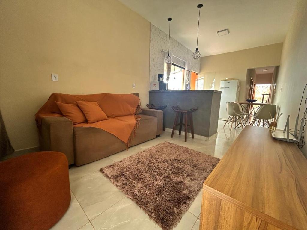 a living room with a couch and a table at Casa, Delfinópolis - Serra da Canastra, MG in Delfinópolis