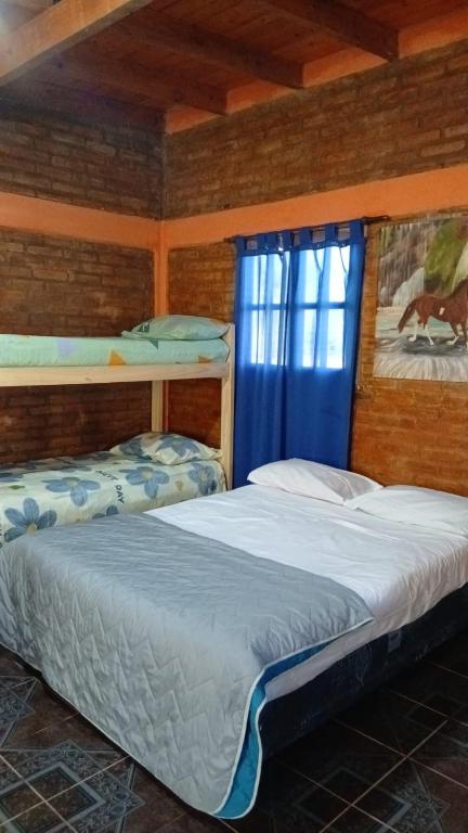 a bedroom with two bunk beds and a window at Cabañas Arelí in Santa María