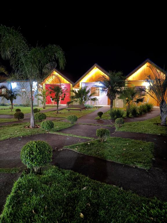 a house with lights on it at night at Chácara Bora Bora in São Bento do Sapucaí