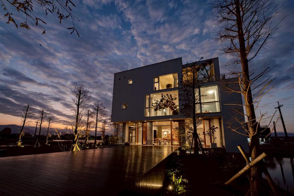 a large black building with a sunset in the background at Sugar House in Wujie