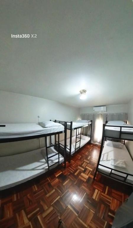 two bunk beds in a room with a wooden floor at Hostel FreeWay in Brasília