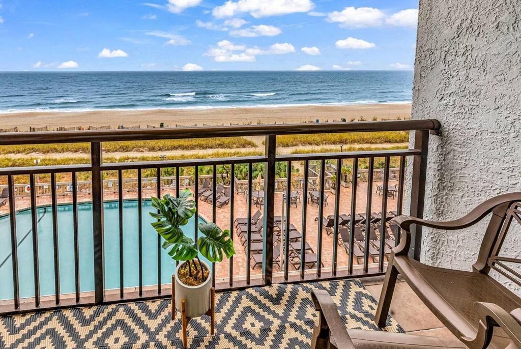 a balcony with a view of the beach and a pool at Last Chance Summer, Oceanfront Pools and Beach in Myrtle Beach